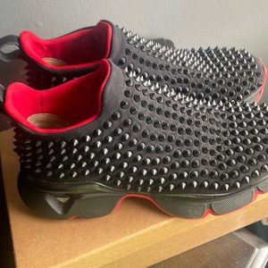 Black Christian Louboutin runners with the black studs.